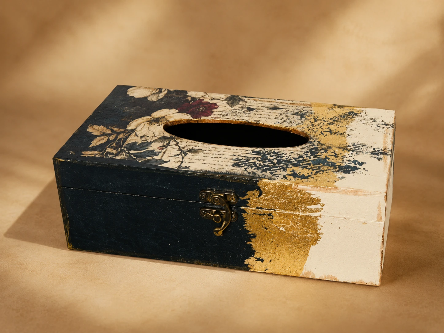 Noir Gold tissue box in black, ivory and antique-gold tones, with a front clasp